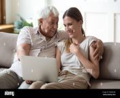 excited mature dad and adult daughter laugh using laptop 2awe2hw.jpg from amature dad xx