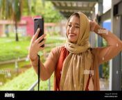 happy young beautiful indian muslim woman taking selfie at the park 2bx918d.jpg from indian muslim selfie
