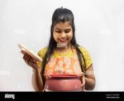 a pretty indian housewife woman in cooking apron with opening serving casserole on white background 2gn3mdd.jpg from rack an telugu house wife