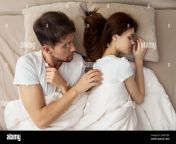 man touching sleeping woman in bed over shoulder top view 2gme7b0.jpg from sleeping touch