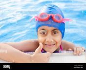portrait of a happy and smiling indian girl child in the swimming pool wearing swimming cap and goggles showing thumbs up sign with thumb finger 2e1cj86.jpg from cute indian swimming pool fuckdian sexy xxxx papa se chudai video sex