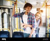 young beautiful charming girl is displaying affection toward her handsome young boyfriend trough the hug as they stand on the bus 2djay3m.jpg from bf bus