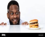 funny hungry black man looking at burger over white background 2dtndcr.jpg from hungry desi looking for something to eat on tiktok xxx