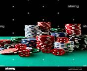 pile of casino pocker gambling chips and dices on green table 2g8677m.jpg from pocker