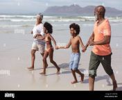 african american grandparents and grandchildren holding hands walking on the beach 2f9tyf8.jpg from beach grandpa