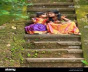 south indian girl kids wearing beautiful traditional dress long skirt and blousesitting on the long steps of a house covered with moss green fungus 2ftjmpg.jpg from indian village mpg download