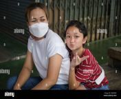 a thai mother and her daughter posing in a market in bangkok thailand 2hj5pm9.jpg from thailand mom