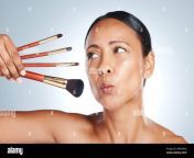 face beauty and senior woman with makeup brushes in studio isolated on a gray background cosmetics skincare products and mature female model pout 2mfdna2.jpg from mature nl mature women