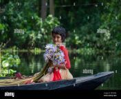 a bangladeshi girl holds a bunch of water lily taken form a large waterbody named `shatla beel at ujirpur in barisal bangladesh 2rtwxe4.jpg from maydar budar ros pora