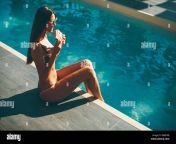 pretty young slim beautiful woman resting by swimming pool in swimsuit and eating watermelon at hot sunny day mafd9b.jpg from beautiful swimming pool hot and sexy
