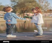 girl and boy playing on the beach at sunset time first lovehappy kids enjoying the lake while having a good time boy gives a girl a beautiful bouq mapx34.jpg from 10 old little girl first time s xvédeo net