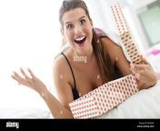 young woman unpacking a surprise present in bed mf0e60.jpg from sleep surprise