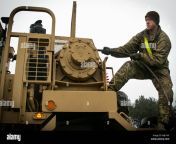 spc tyrel denton a military truck driver assigned to the 32nd composite truck company 68th combat sustainment support battalion 4th sustainment brigade 4th infantry division unrolls a cable on a heavy equipment transport system hets on order to tow another vehicle at an airfield near pozwidz poland dec 5 2017 denton a rushville neb native and the other us soldiers in his unit are part of a nine month deployment in poland us army photo by spc andrew mcneil 22nd mobile public affairs detachment mjk1hy.jpg from widz mp dawlound