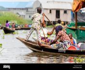 ganvie benin jan 11 2017 unidentified beninese woman with her sons sails in a wooden boat over the lake nokwe benin people suffer of poverty due pc8yyr.jpg from benin vano baby azetogbèdé de benin