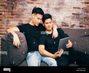 asian gay couple watching and looking at phone tablet together portrait of happy gay men homosexual love concept p2gfd9.jpg from asian gay