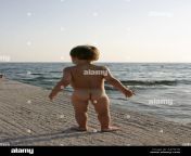 young boy naked nude or bare playing and standing by the sea in saronida a47w1b.jpg from little naked