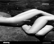 close up of two young adult nude caucasian women lying on boulders a8j9ek.jpg from close nudist