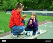 8 year old boy and 7 year old girl eating hot dogs outdoors amw012.jpg from 7 yours sexy8 old saxy 5 minet x