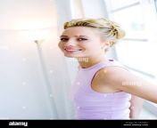 female with blonde hair wearing lilac vest standing against window cf34m2.jpg from flat chest matures