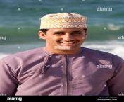 young arab omani man smiling by the sea c10gt6.jpg from arab omani