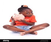 cute little black girl holding a smiling piggy bank isolated on white d86549.jpg from cute ebony with a little holiday arching