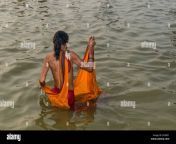 woman wearing an orange sari taking a bath in the sangam the confluence dca0f1.jpg from sharee bathing