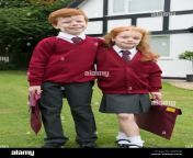 brother and sister in their school uniform outside their home def04b.jpg from school to come sister brother