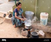 indian woman cooking rice on an open fire outside her home in a rural dp8g3b.jpg from indian desi village home tusan