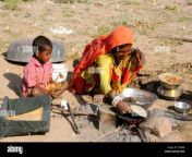 indian rajasthani woman cooking food lunch roti bread in open field et0rbj.jpg from rajasthani village wife open her share