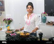 young indian woman in a kitchen preparing ayurvedic food hdfjg9.jpg from desi wife in kitchen