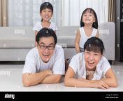 happy asian chinese parents and daughters lying on the floor in the hwnt1j.jpg from chinese with south lying