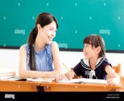 young teacher helping child with writing lesson jhtmyw.jpg from teacher and student chinese