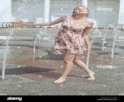 wet woman plays in the fountain with splashes a summer hot day jtyjcd.jpg from hot wet mom