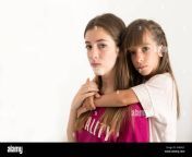 portrait of two 15 and 10 year old sisters on a white background it knba2c.jpg from 10 sister b