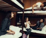 group of young travelers in hostel room 560x420.jpg from amu hostel sex in hostel rooms