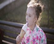 videoblocks little girl eating ice cream in the park snm8lofnf thumbnail 1080 01.png from little with cream