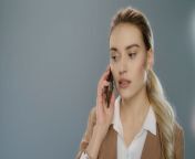 videoblocks serious business woman talking mobile phone on gray background portrait of young businesswoman calling phone in studio female professional have mobile conversation on smartphone swkyh8rfe thumbnail 1080 01.png from mobile talk